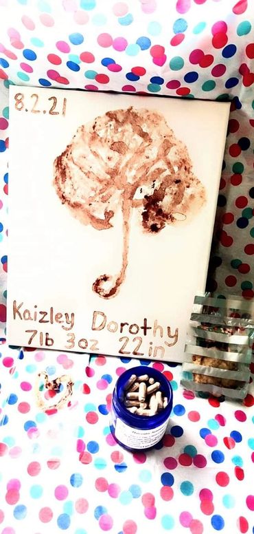 A newborn keepsake with birth details and a painted footprint on a polka dot background.