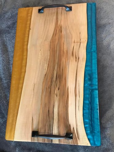 Charcuterie board with blue and gold resin accents.