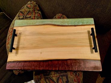 Charcuterie board with resin accents on both sides.