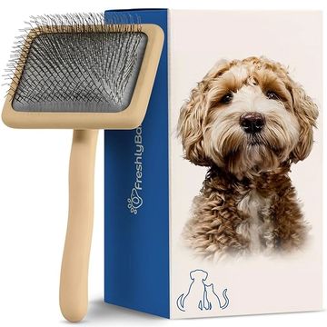 Dog grooming slicker brush with long bristles.