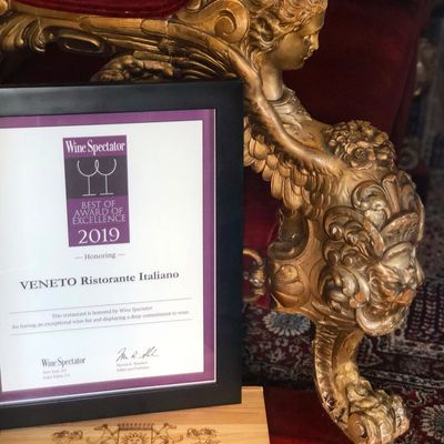 Wine Spectator Best of Award of Excellence winner displayed with antique Italian settee sofa
