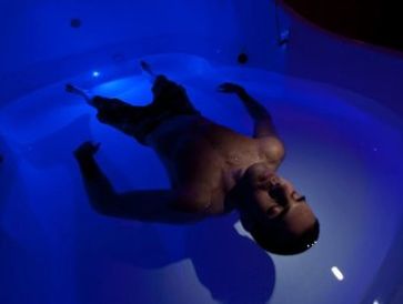Man floating in float therapy room
