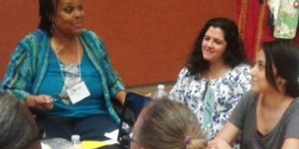 Dr. Applewhite discussing career development at table with students from Disability Resource Dept.