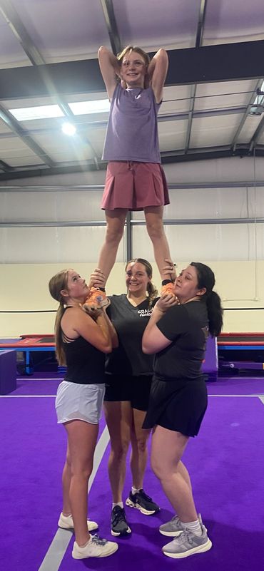 Cheerleaders stunting butte cheer company cheer in Chico