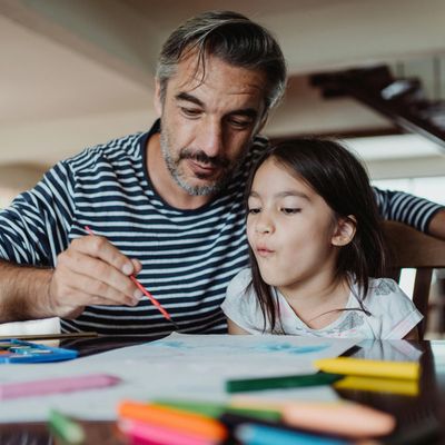 man painting with a child
