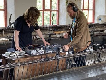 Maryanne Royle & film-maker Harry Wheeler during filming at the museum. They look down at equipment