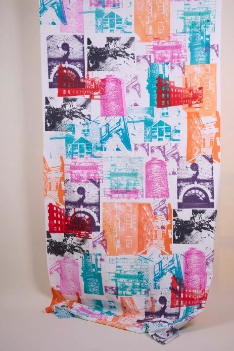 Brightly coloured banner,  printed all over  with photos of mill buildings, street scenes brickwork