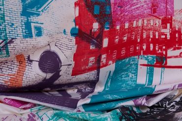 Part of a banner: screenprinted photos on white fabric. Photos of brickwork, mill buildings & detail