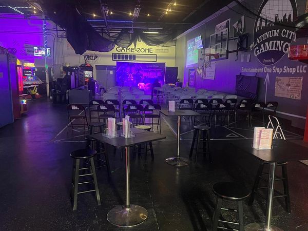 Interior of a gaming arcade with seating and tables set up for an event. platinum city gaming photos
platinum gaming