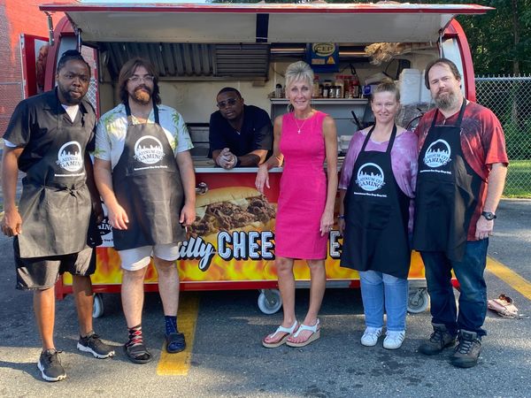 Group of six people posing in front of a food truck, four wearing aprons with a gaming logo. platinum city
platinum city gaming
platinum city gaming photos
platinum gaming