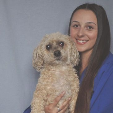 Brittany Duque (Owner and Trainer) holding Mya (shih tzu mix dog)