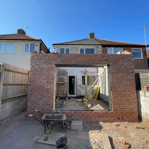 Brick extension under construction at a house.