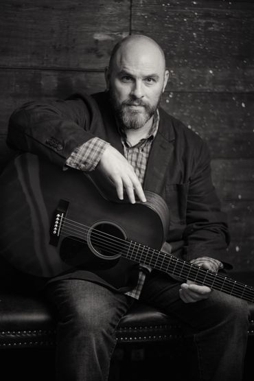 Photo courtesy of www.pauldahm.com. CONANT plays guitar as well!