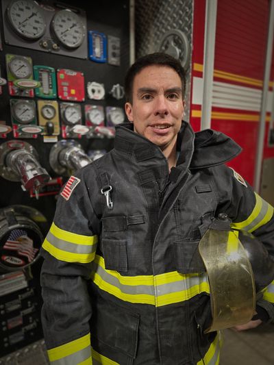 FF/EMT Eric Scholl next to his fire engine after a training for a local Fire Dept.