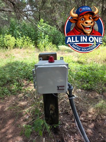 Outdoor electrical control box with All In One Septic Solutions logo.