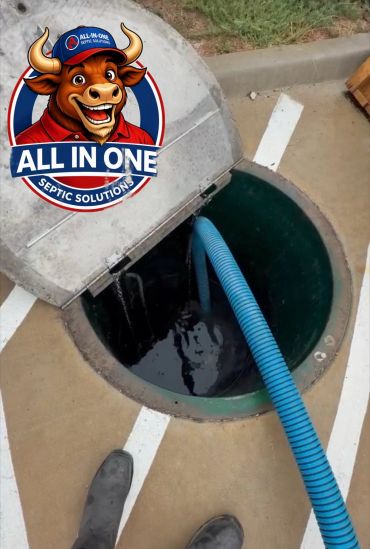 Septic tank cleaning with a blue hose and company logo.