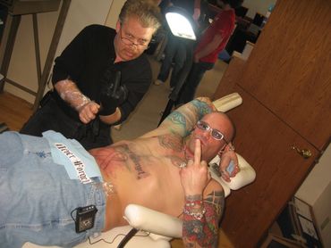 Bob Bowers' HIV/AIDS red ribbon stomach tattoo