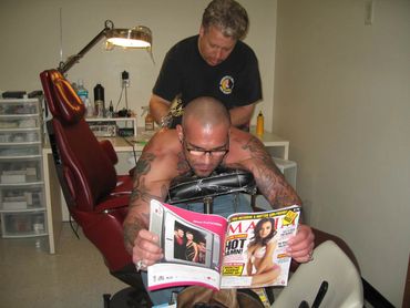 Bob Bowers in the tattoo chair being tattooed by Mark Detter Smooth Fx in Sauk City Wisconsin