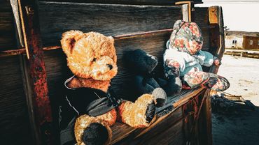 The Ribbon Warrior MC teddy bears sitting on a bench for HIV/AIDS awareness