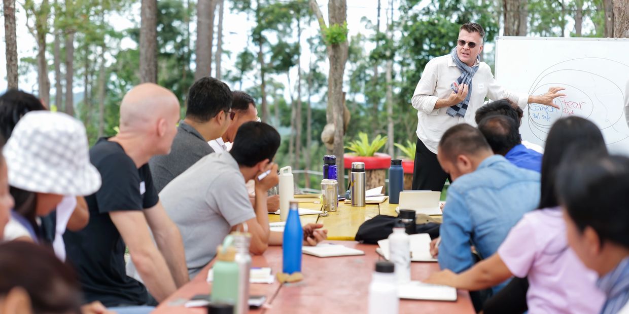 a picture with coach Noel and attendees of the course at Kirirom retreat