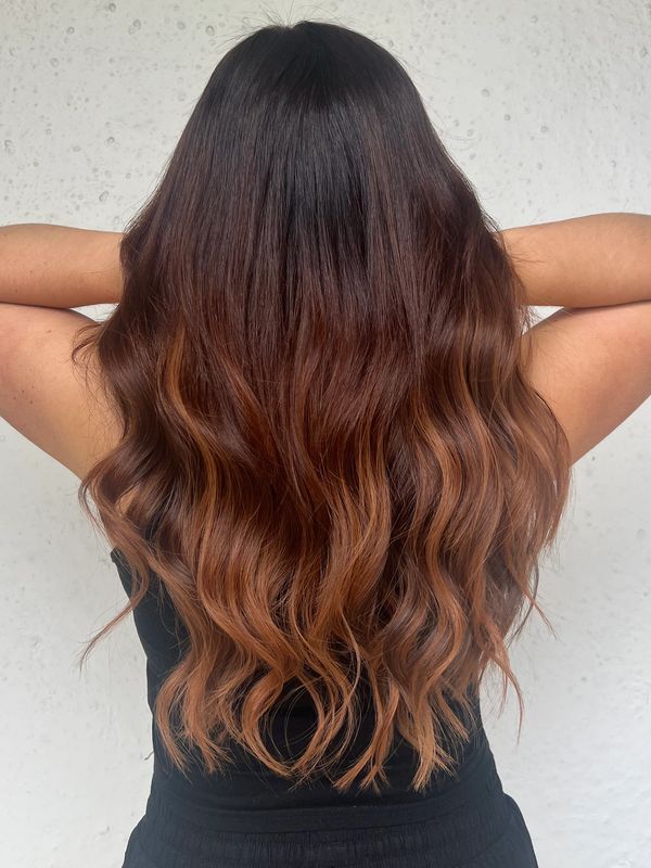 Long wavy hair with ombre coloring.