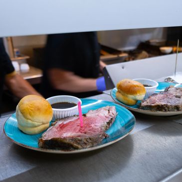 "In a bustling kitchen, two chefs clad in black collaborate seamlessly, Cooking American cuisine.