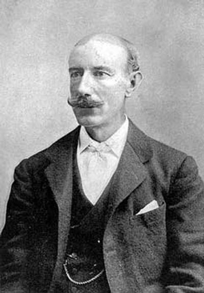 Black and white portrait of a distinguished man with a mustache in formal attire.