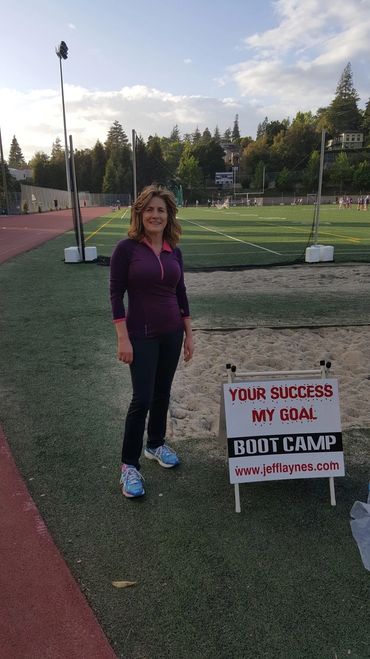 Lady pose for picture besides a banner