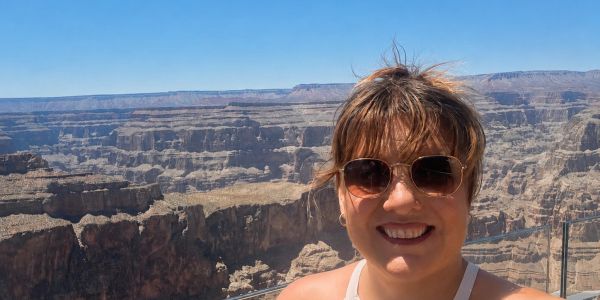 Woman smiling with canyon background.