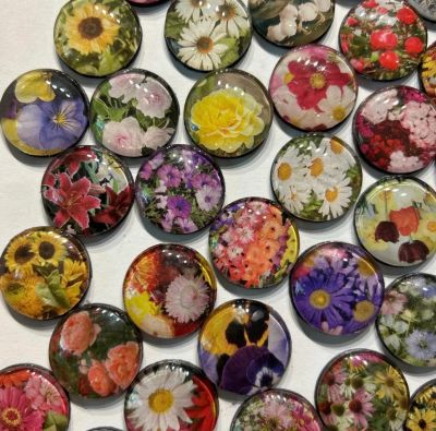Colorful round magnets with various floral designs.