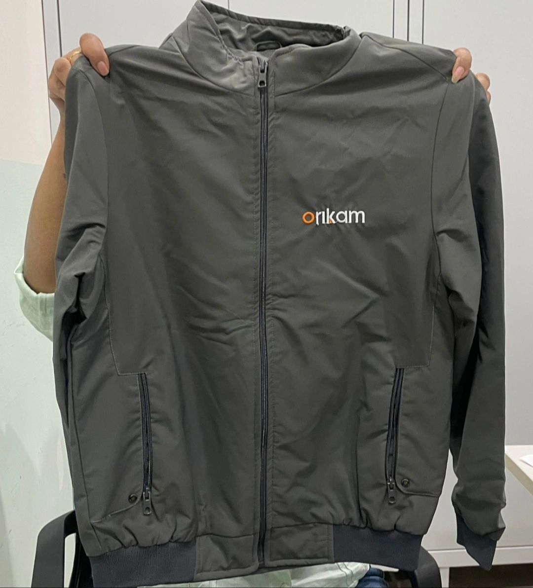 Dark gray Orkam jacket with front zipper and pockets.