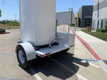 alt="Portable restroom trailer for sewer line repair and maintenance teams"