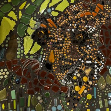 Detailed mosaic of a playful cat face.