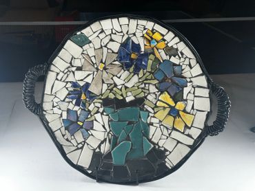 Flower mosaic on a vibrant plate.