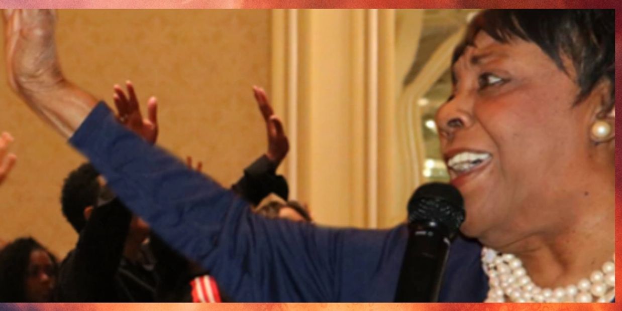 Dr. Mildred C. Harris encouraging the audience to give praises unto the Lord.