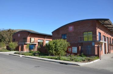 Two modern brick office buildings under a clear blue sky.