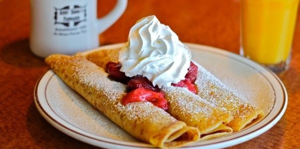 Delicious strawberry crepes with whipped cream and orange juice at Aunt Emma's Pancakes in San Diego