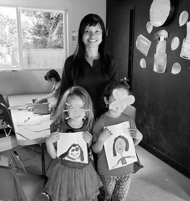 Students share their drawings with teacher.