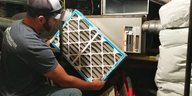 Servicing furnace in crawl space replacing air filter