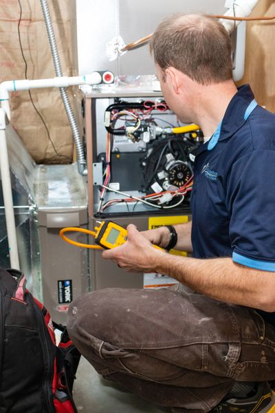 Working on the furnace completing a service call