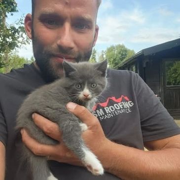 Adam with one his favourite animals, a customers pet cat