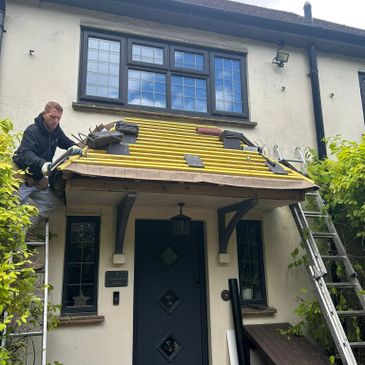Front door porch roof being retiled