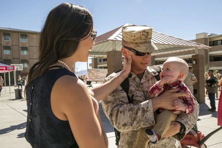 Marine and wife holding baby