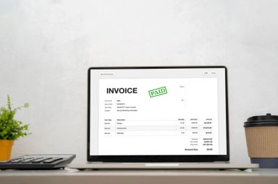 Laptop screen displaying a paid invoice.