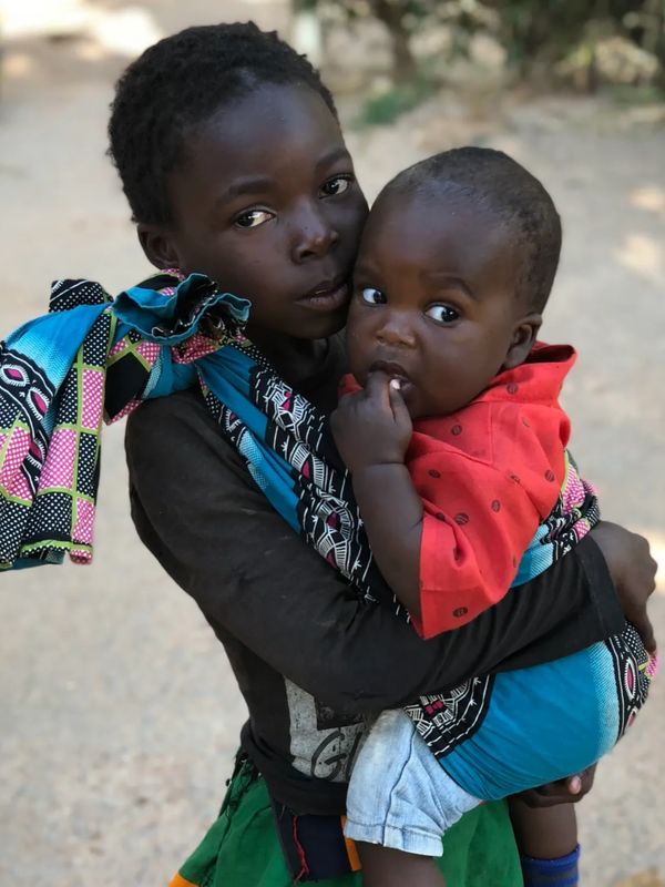 Zambian girl holding baby brother