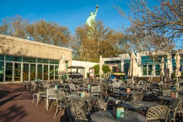 Crown Café (to the left) and the main Gift Store (to the right) on the patio on Liberty Island.