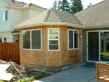 A house extension under construction with new windows and roof.
