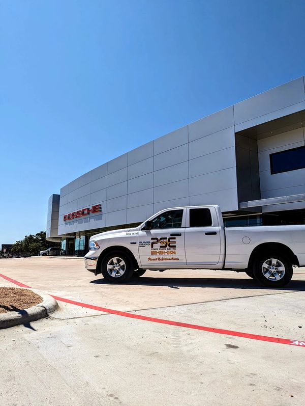 Power Source truck parked in front of completed project at Porsche San Antonio