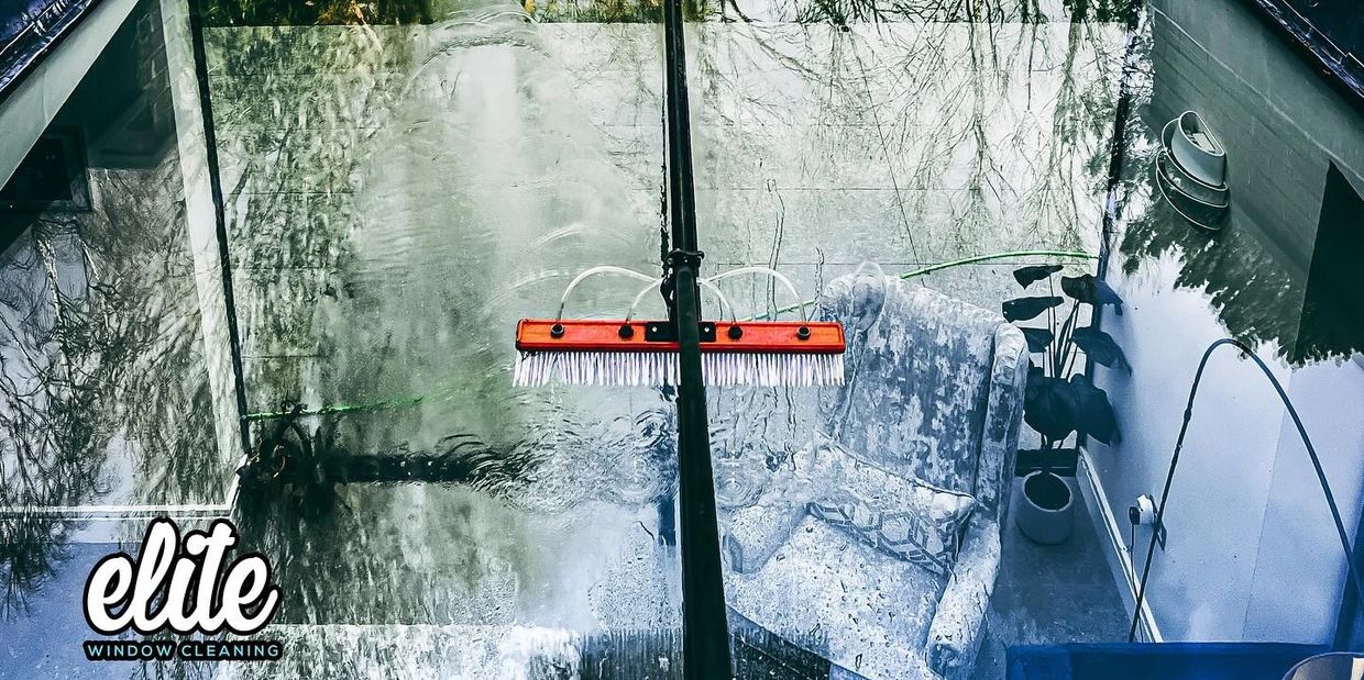 A large window being cleaned with a garden view in the background.Window Cleaner Milton Keynes | MK Window Cleaning Milton Keynes Window Cleaning