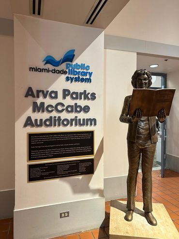 Statue of Arva Parks McCabe reading a book at Miami-Dade Public Library.